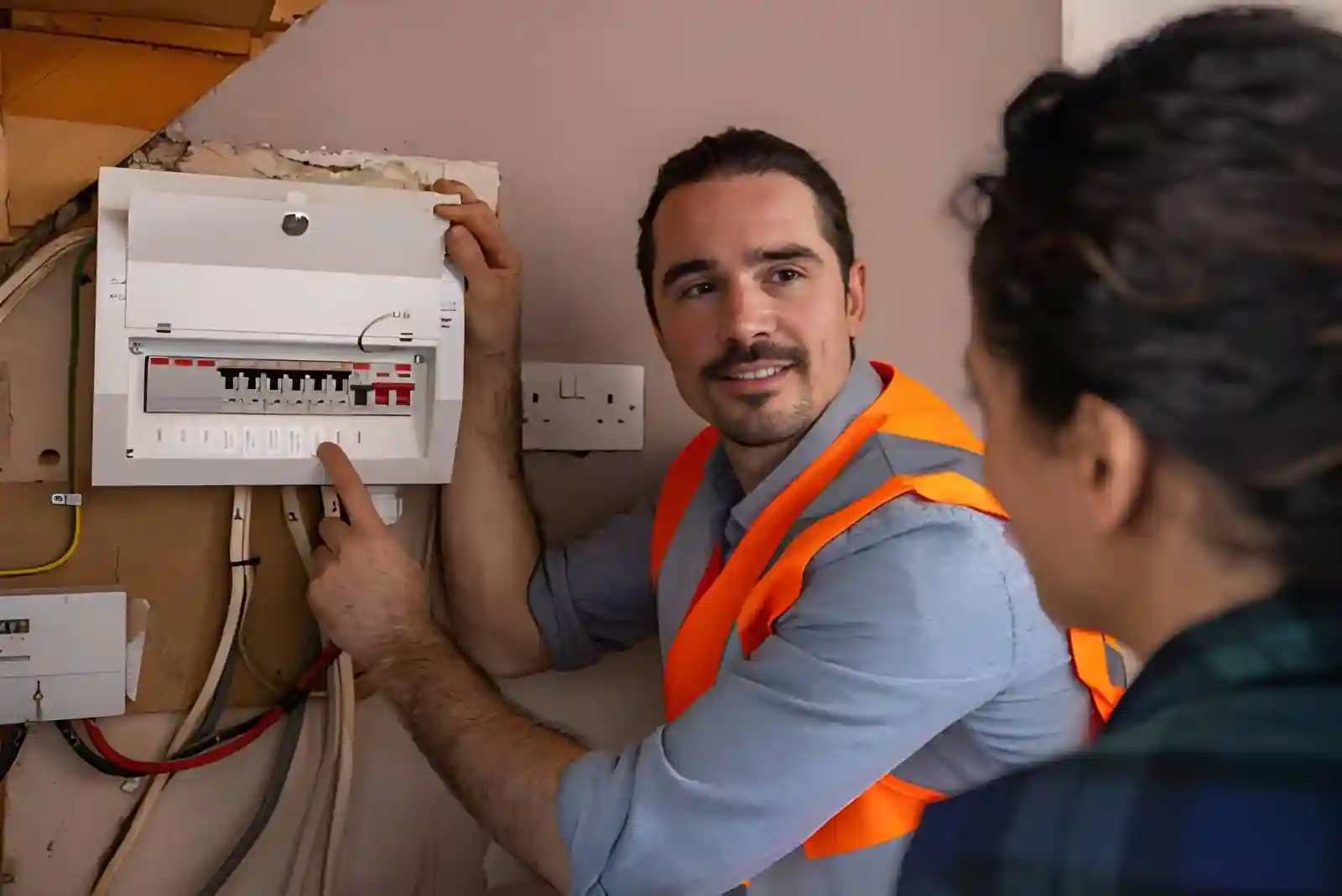 Electrician performing EICR inspection in a rental property fuse box for landlord compliance and safety check.