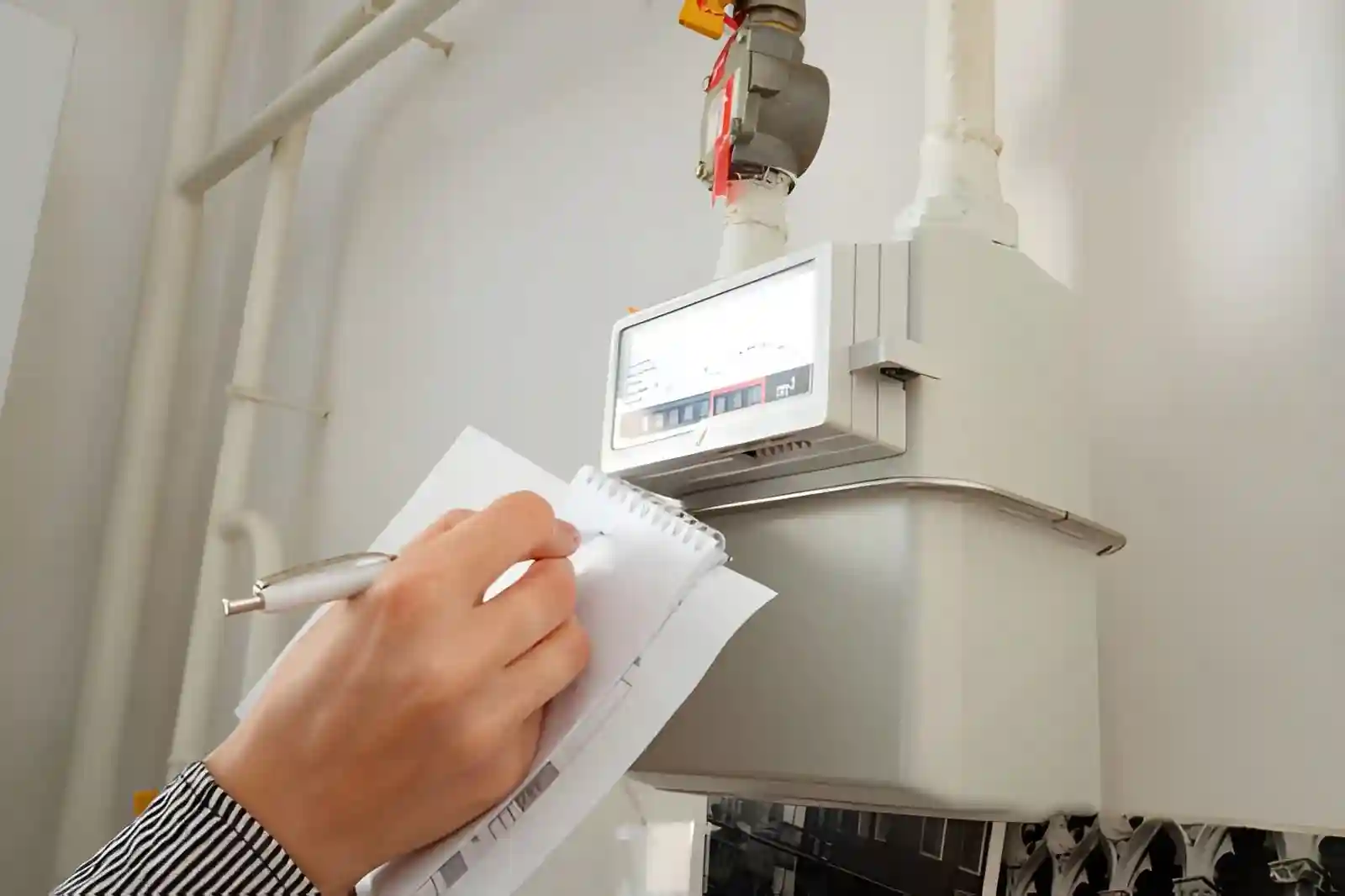 Gas engineer carrying out a Gas Safe Register Check in a residential kitchen